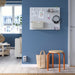 A modern and well-organized interior featuring an IKEA SKÅDIS pegboard mounted on a blue wall. The pegboard holds various accessories, including decorative cards, a fabric pouch, black headphones, and keychains.-60599519