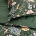 Floral patterned bedding set on a green background