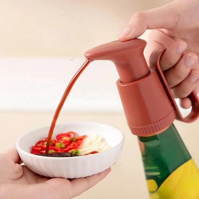 Person pouring red sauce from a bottle into a bowl of food.