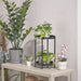 IKEA FEJKA artificial potted plant – wax plant displayed on tabletop with books, lamp, and abstract wall art - 90614226
