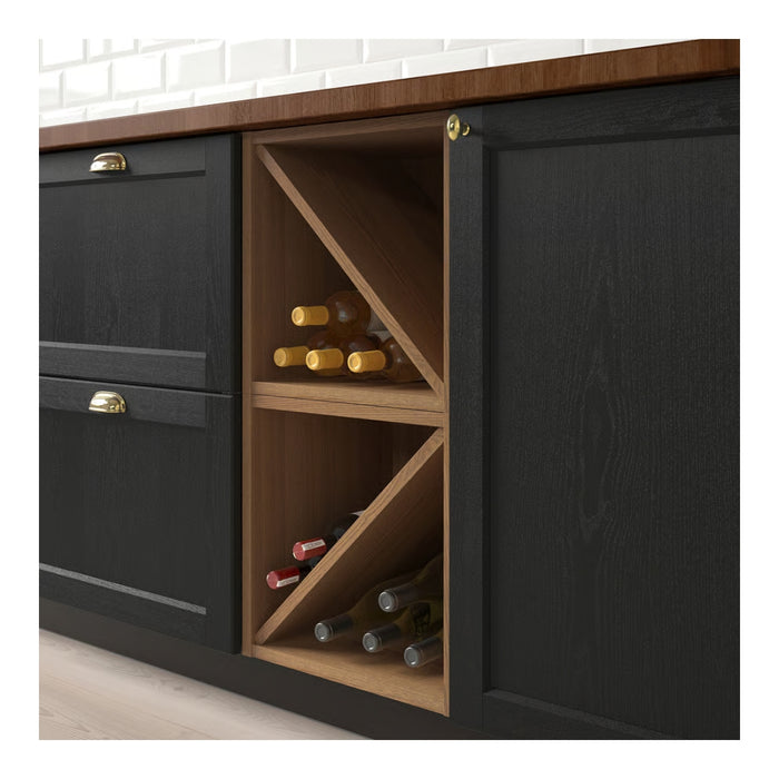 Black kitchen cabinet with wooden wine rack containing bottles.