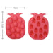 Two pink silicone pineapple-shaped ice cube trays with measurements on a white background
