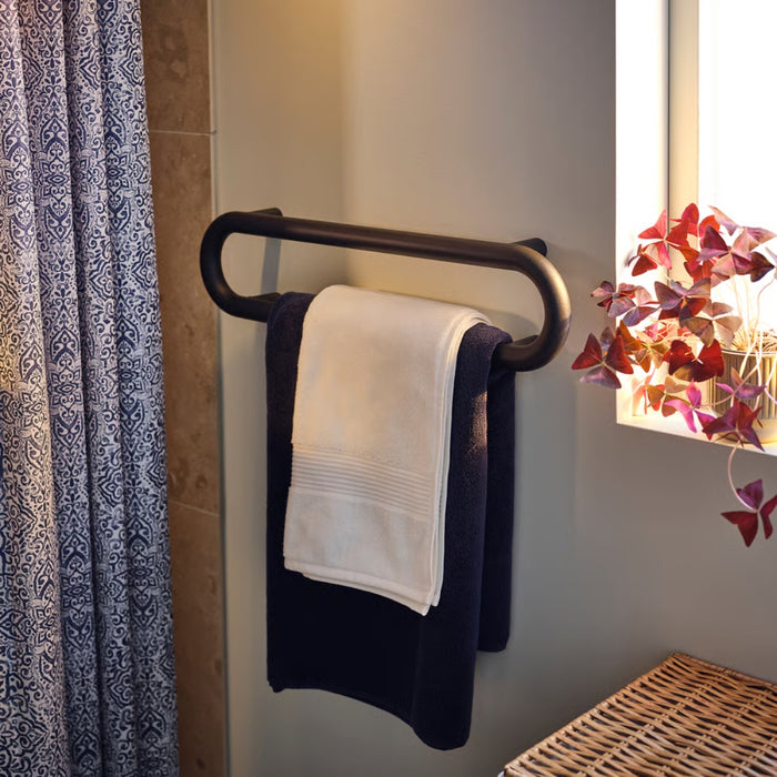 Towel rack with towels in a bathroom setting