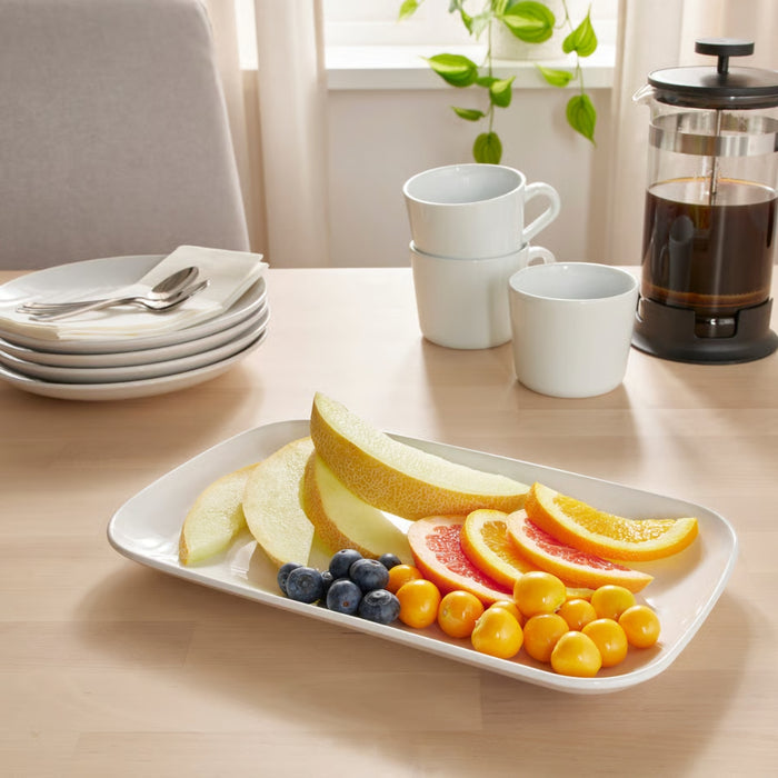 Fruit platter with a coffee maker on a table