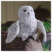 IKEA SKOGSDUVA soft toy – snowy owl plush with yellow eyes and speckled wings, perched on striped fabric surface - 50576896

