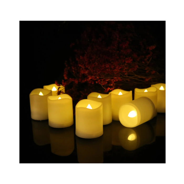 Flickering candles on a reflective surface with a dark background