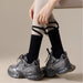 Digital Shoppy Foot Sole Non-slip Yoga Socks – Black socks with ribbon straps styled over tights and chunky sneakers
