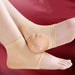 Beige ankle support brace on a foot against a red background