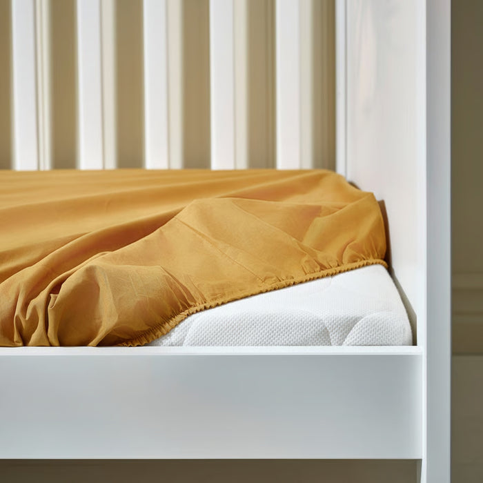 Close-up of IKEA GULDVÄVARE colorful fitted sheet on baby cot