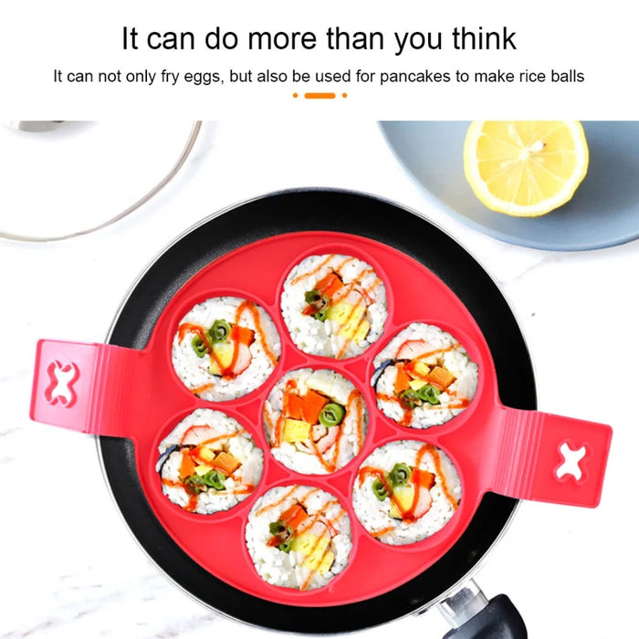 Red silicone 7-hole cooking mold placed in a frying pan, filled with seasoned rice balls topped with colorful ingredients like vegetables and sauces—showcasing its versatility beyond eggs and pancakes. Text at the top reads: “It can do more than you think. It can not only fry eggs, but also be used for pancakes to make rice balls.” Ideal for creative meals and fun presentations -2147192 13025440.