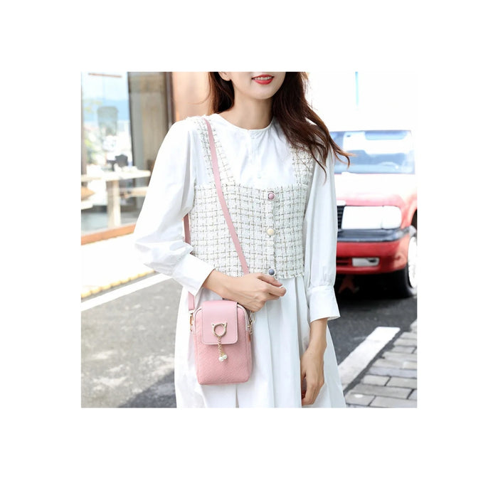Woman holding a pink handbag on a city street