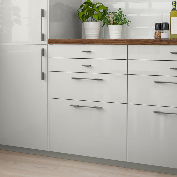 IKEA RINGHULT Drawer front, high-gloss light grey, 40x10 cm, installed in modern kitchen with wine glasses and potted plants - 70327189