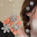 Crystal snowflake jewelry – earrings and rings worn with braided hair and fluffy white garment