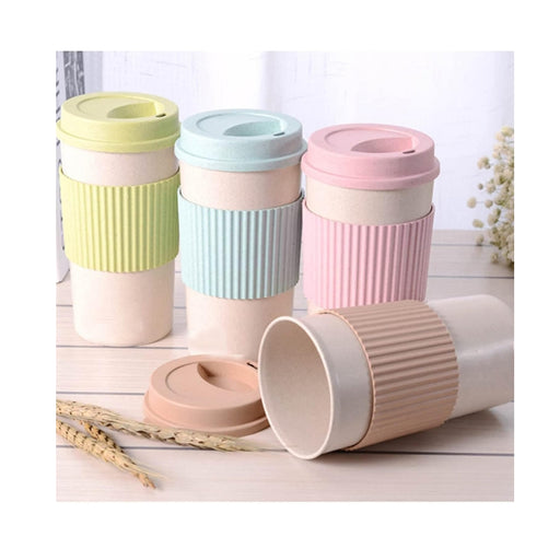 Set of pastel-colored travel mugs with ribbed design on a light wooden surface.