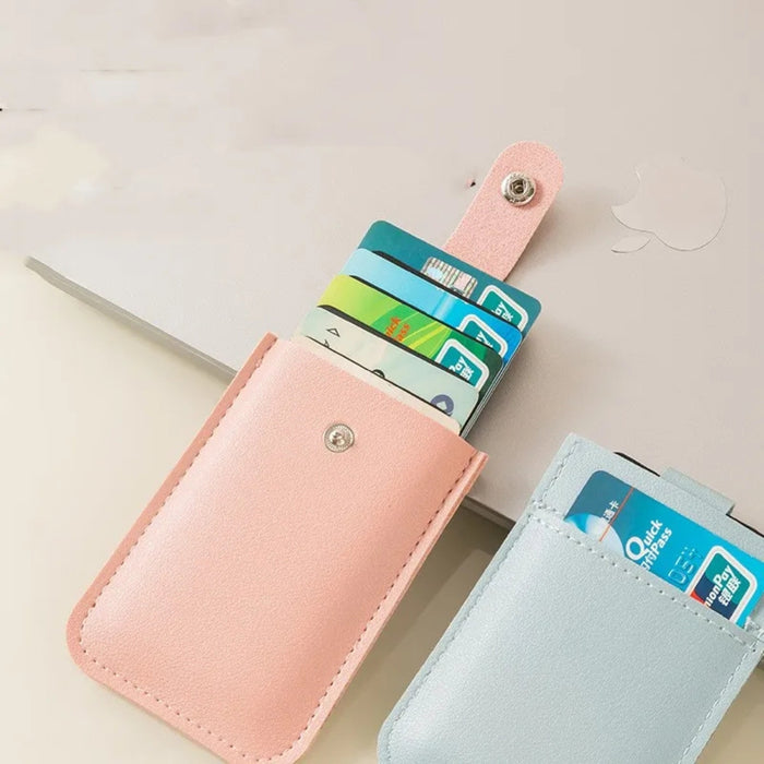 Pink and light blue card holders with cards inside on a light background