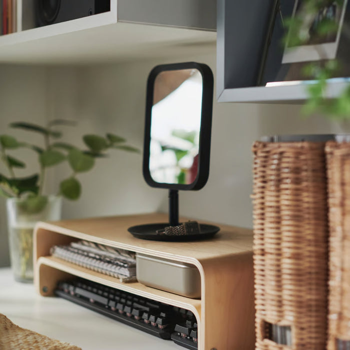 LINDBYN compact oval mirror by IKEA standing on desk with minimalist design