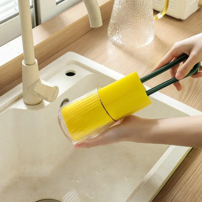 Dual sponge brush with yellow heads and green handles used to clean glass cup in white sink – ideal for bottles and deep kitchenware – 1598453485864 13972338