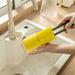 Dual sponge brush with yellow heads and green handles used to clean glass cup in white sink – ideal for bottles and deep kitchenware – 1598453485864 13972338
