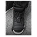 Black high-top sneaker with white sole on a gray pavement background