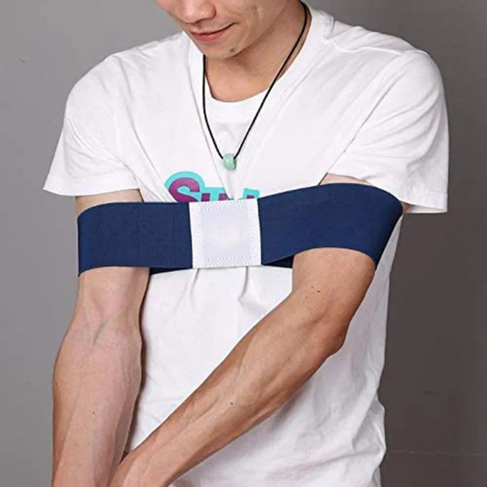 Person wearing a white t-shirt with a blue arm brace on a gray background