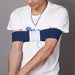 Person wearing a white t-shirt with a blue arm brace on a gray background