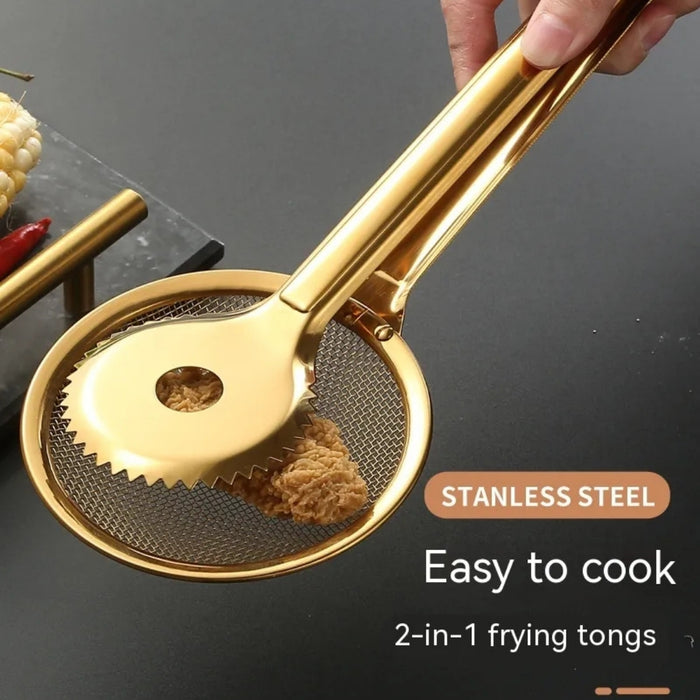 Close-up of golden stainless steel 2-in-1 frying tongs holding a crispy fried item. The tong head features a unique design combining a mesh strainer with a serrated grip for efficient oil drainage and secure handling. Text overlay reads: “STAINLESS STEEL – Easy to cook – 2-in-1 frying tongs,” emphasizing its dual functionality and user-friendly design.- 1600003112383 13034147
