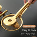 Close-up of golden stainless steel 2-in-1 frying tongs holding a crispy fried item. The tong head features a unique design combining a mesh strainer with a serrated grip for efficient oil drainage and secure handling. Text overlay reads: “STAINLESS STEEL – Easy to cook – 2-in-1 frying tongs,” emphasizing its dual functionality and user-friendly design.- 1600003112383 13034147
