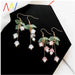 Digital Shoppy Lily of the Valley earrings – floral drop earrings with translucent pink and white blossoms, gold hooks and stems

