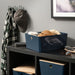 KUGGIS box used in entryway shelf, storing folded clothes and accessories like sunglasses, wallet, and keys