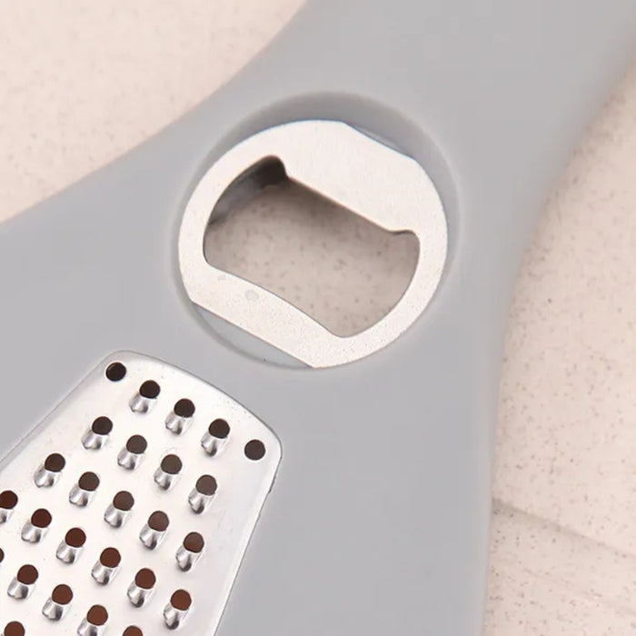 Multifunctional tool with grating surface and bottle opener on a gray background