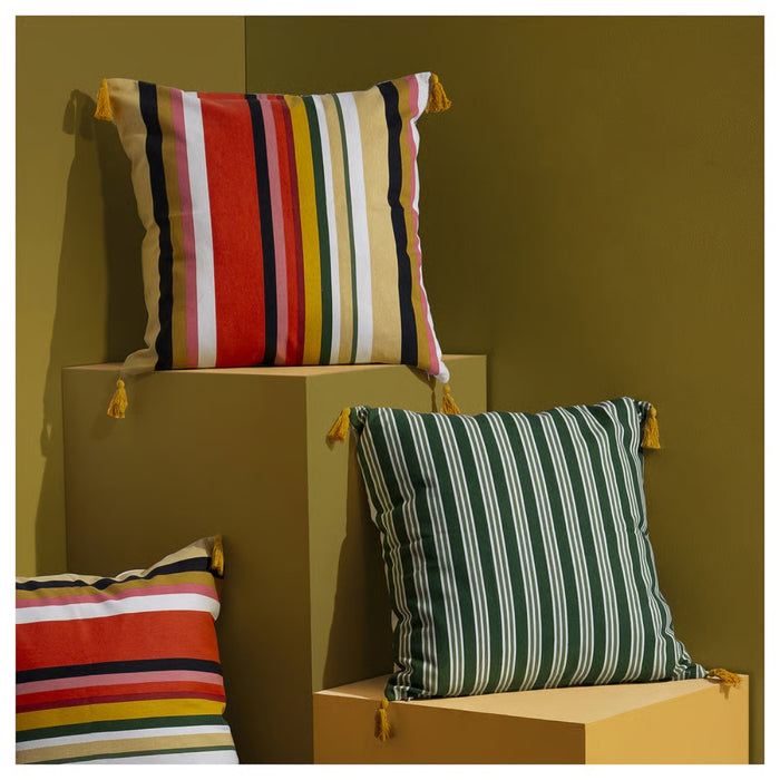 Colorful striped pillows on geometric wooden blocks against a brown background