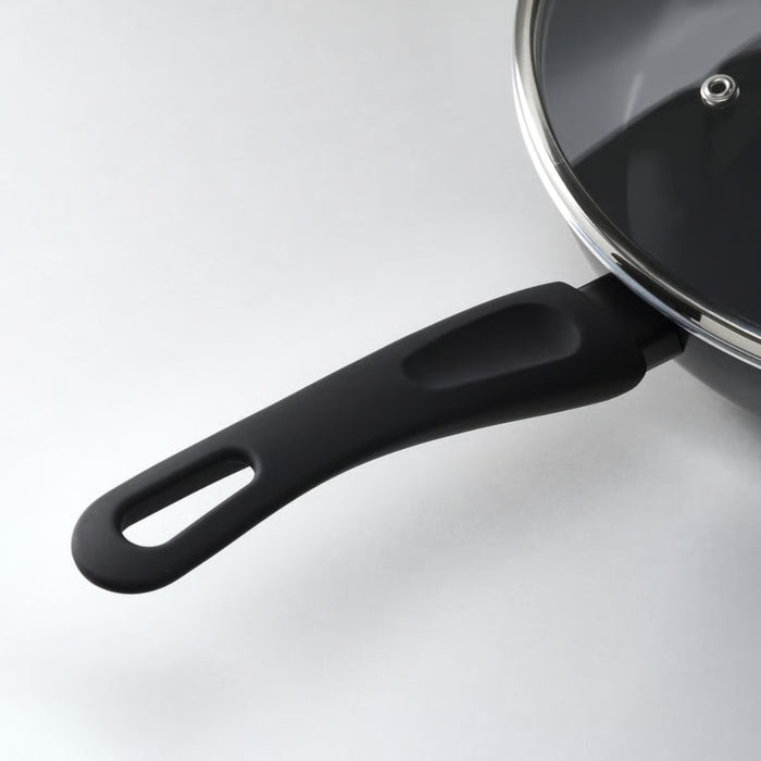 Black frying pan with a lid on a white background