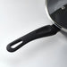 Black frying pan with a lid on a white background