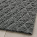 Close-up of IKEA ÖSTERILD indoor door mat in dark grey with raised diamond texture; soft surface placed on light wood floor – 60511116