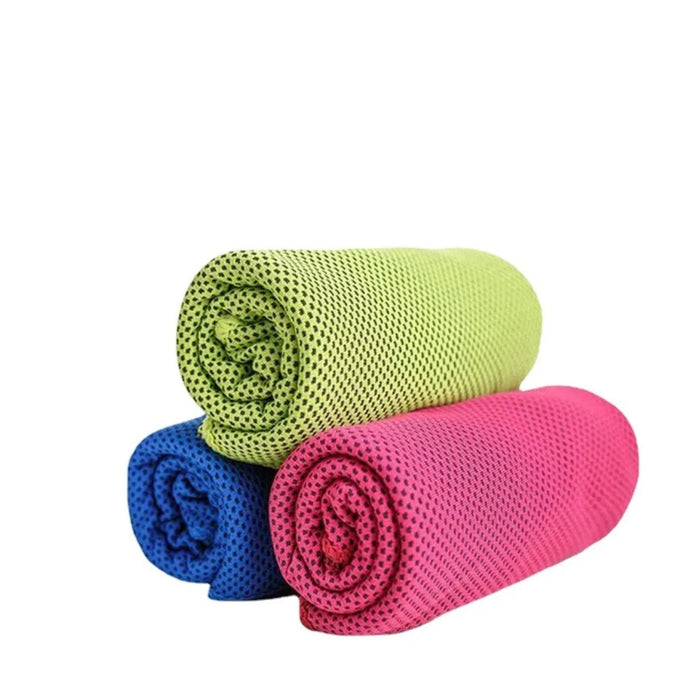 Three rolled-up cooling towels in green, blue, and pink on a white background