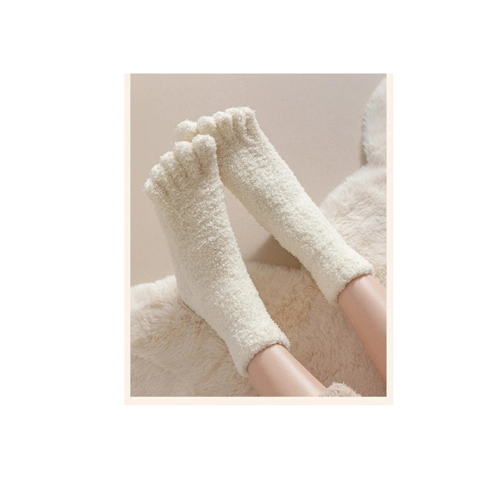 White fluffy socks worn on a person's feet with a neutral background