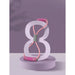 Hourglass-shaped object with pink and green elements on a purple background
