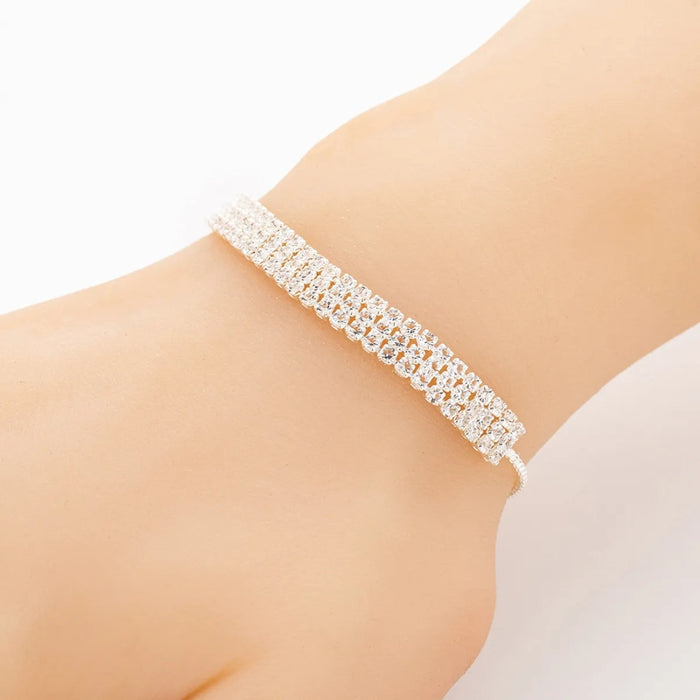 Silver bracelet on a person's wrist against a white background