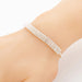 Silver bracelet on a person's wrist against a white background
