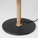 Floor lamp with wooden pole and black marble base on a light gray background