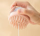Pink silicone scalp massager with flexible bristles and a transparent liquid compartment. Designed for shampoo or conditioner application while providing a gentle massage to improve scalp health and product absorption- 159845334887912362179
