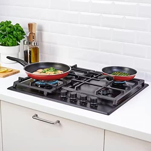 Black gas cooktop with two frying pans on a kitchen counter.