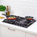Black gas cooktop with two frying pans on a kitchen counter.