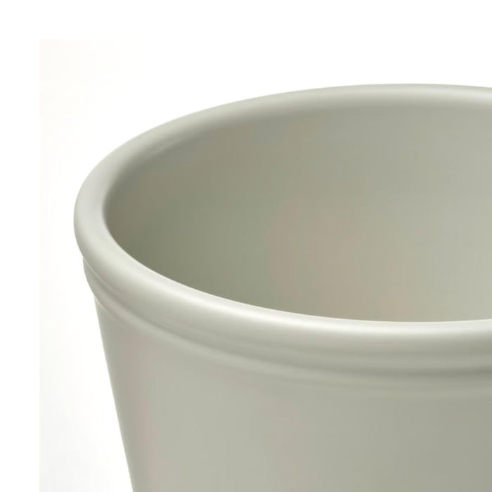 Close-up of IKEA KÖRSBÄRSBJÖRK smooth earthenware finish in light grey-beige showing texture and form