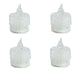 Four clear LED candles with a white base on a white background