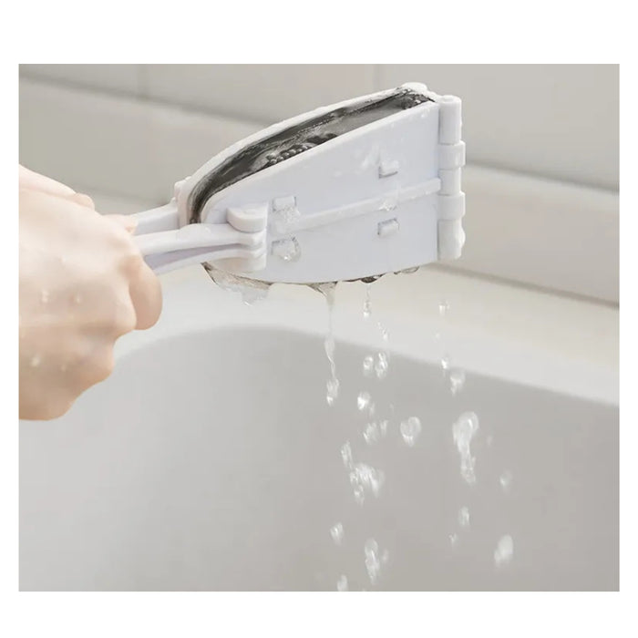 Person using a squeegee to clean a window with water droplets visible