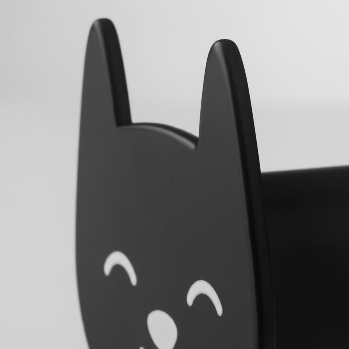 A black cat-shaped wall hook with pointed ears and closed eyes, mounted on a light-colored wall. Minimalist, decorative, and functional storage for accessories or clothing.-90567791
