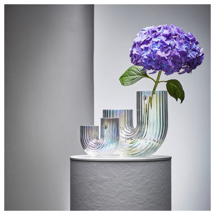Decorative vase with a purple flower on a gray background