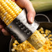 Corn shucker being used to remove kernels from a cob