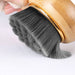 bamboo handle facial brush close‑up showing dense gray bristles